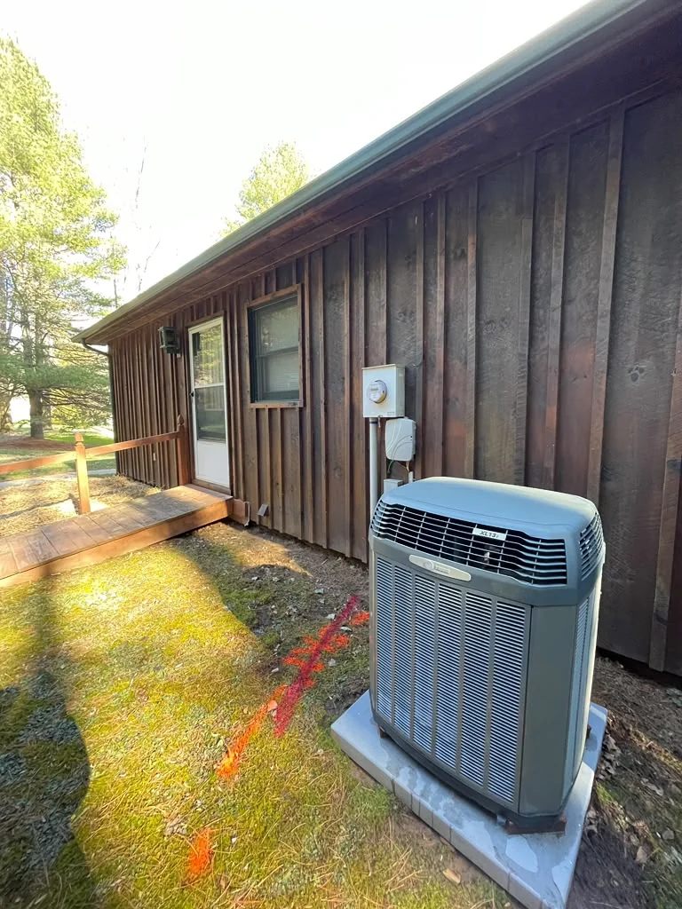 Dark board-and-batten wood siding before refinishing